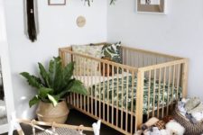 18 a boho nursery with potted greenery, macrame, wicker baskets and a printed rug