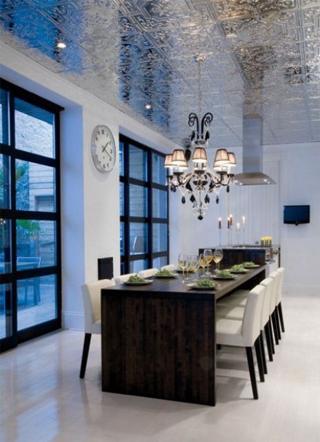 a super shiny patterned silver ceiling adds interest and a whimsy touch to the dining space