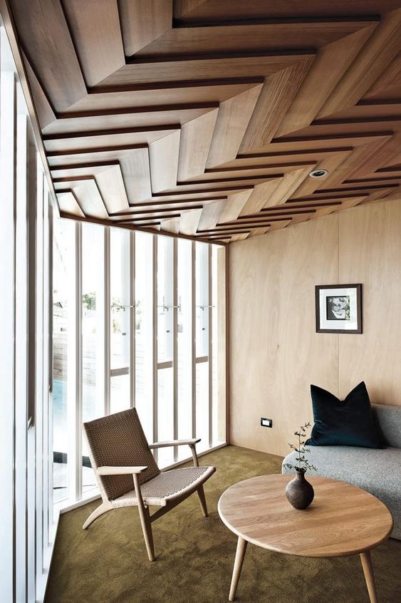 a dimensional wood clad ceiling with a chevron pattern is a bold idea with a modern feel - geometry is very edgy