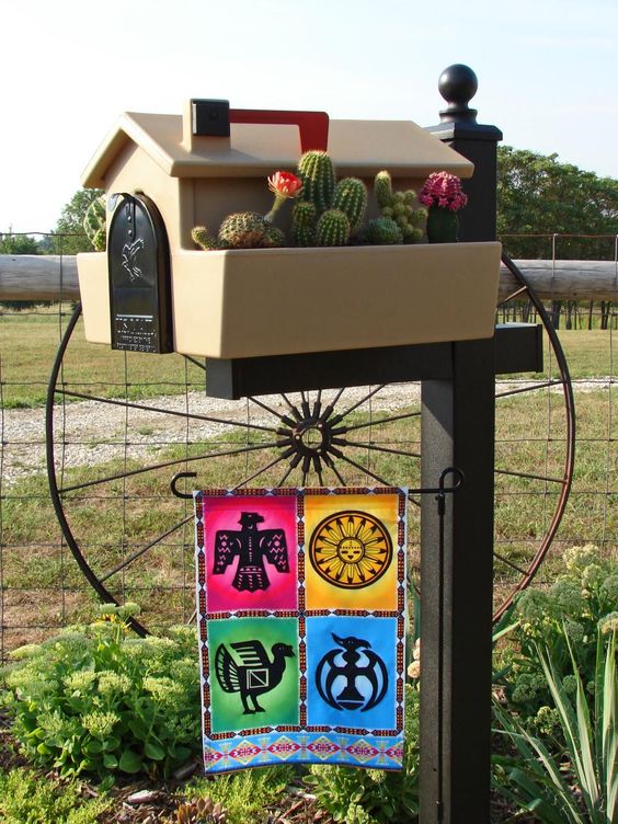 a gorgeous home mailbox with a cacti garden and a colorful Mexican-inspired banner