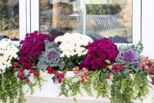 19 a white window box planter with burgundy and white blooms, foliage, cabbages, berries