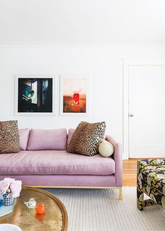 a lilac and gold sofa and leopard print pillows as accessories create a bold look and a color statement
