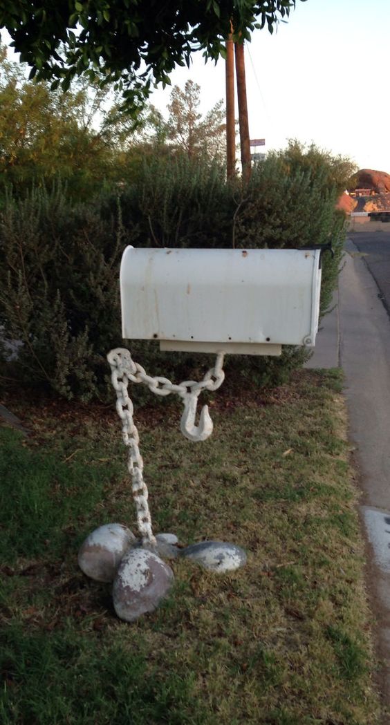 a mailbox being help up by a chain looks as if it's really hanging in the air, so bold and cool