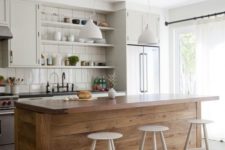 21 a large kitchen island clad with wood contrasts the neutral kitchen