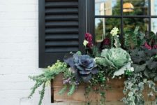 21 a rustic wooden window box planter with cabbages, blooms, foliage and little flowers looks cool