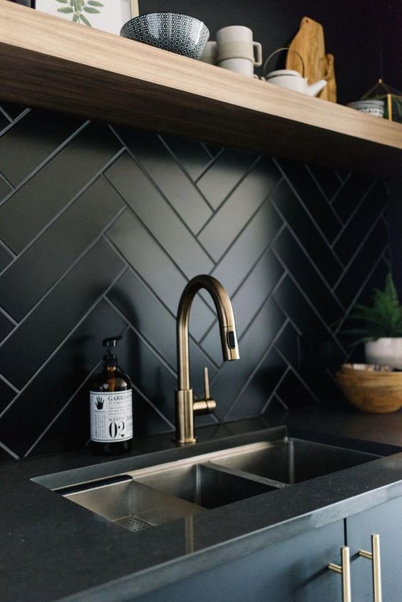 a black tile kitchen herringbone backsplash is a chic idea for a modern space