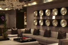 22 an exquisite and chic living room with a metallic ceiling, a bubble chandelier and wall lamps