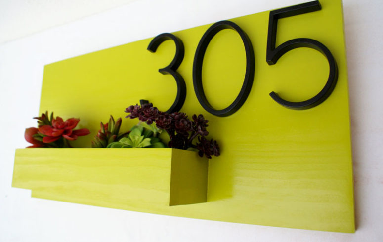 a neon planter with house numbers and succulents and blooms will add a touch of color to your outdoor space
