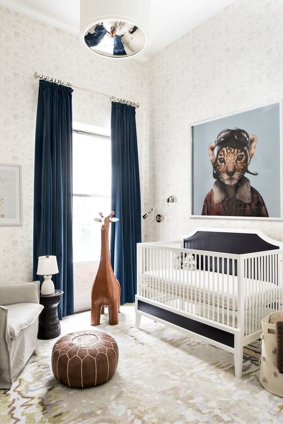a whimsy modern nursery decorated with a leather ottoman, a large toy giraffe, an artwork and rugs