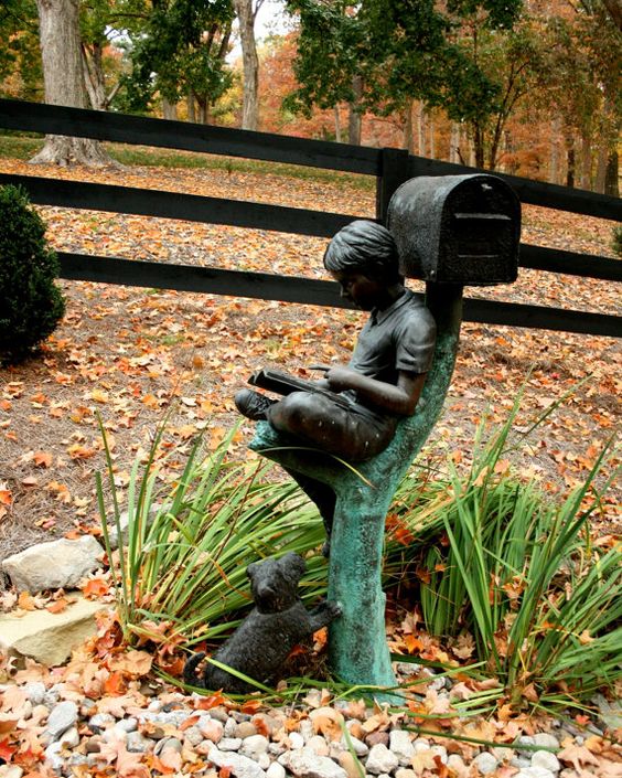 A whole sculpture of a boy and a dog plus s mailbox is a great idea for any outdoor space   it's so dreamy