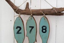 25 hang a piece of driftwood with wooden fish and house numbers on them is a nice idea for a beach home, hang it on the porch