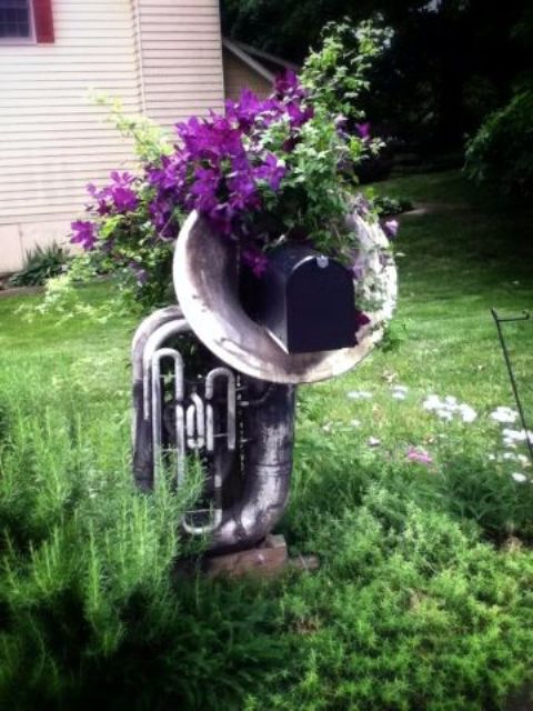 if you are all about music, use an old musaical instrument and some blooms to display your mailbox in a chic way