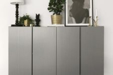 25 two IKEA Ivar cabinets done in grey with paneling and placed on tall legs look very chic and elegant