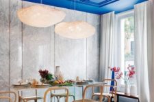 26 an electric blue paneled ceiling is a major color statement and design feature of the dining room