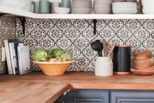 26 bold mosaic patterned tile backsplash brings interest to this simple grey kitchen