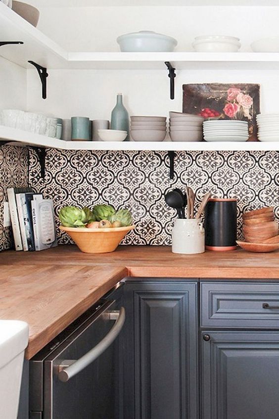 bold mosaic patterned tile backsplash brings interest to this simple grey kitchen