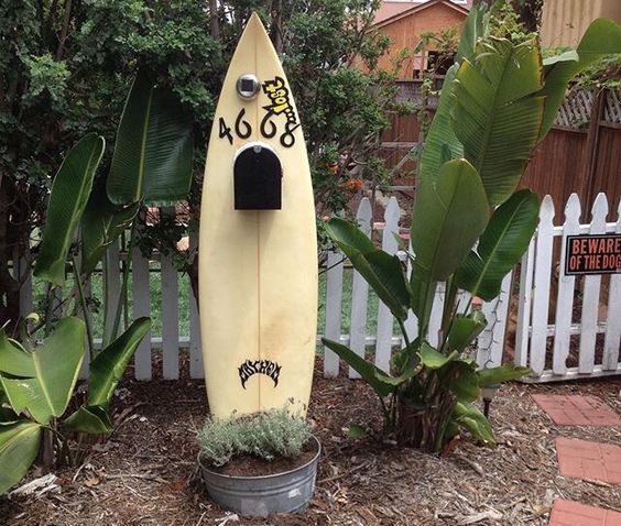 use your old surfboard to display a mailbox - place it into a planter, write your house numbers and attach the box