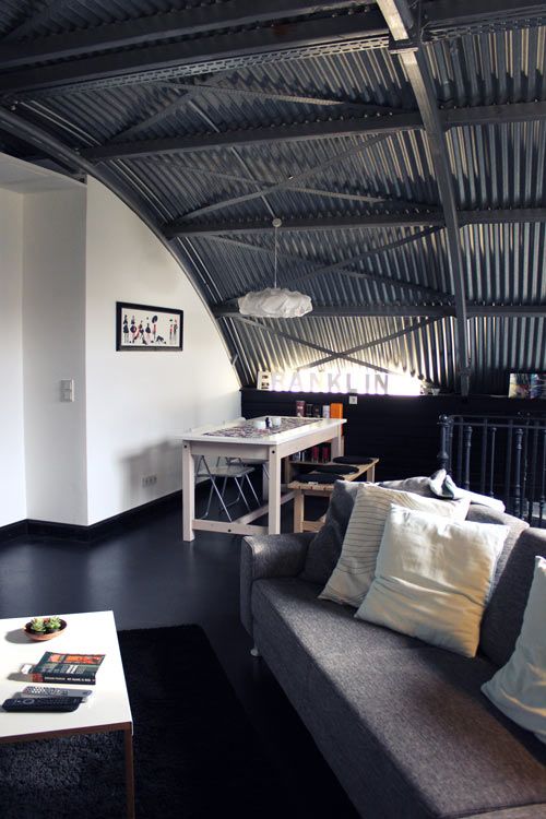 a masculine space with a corrugated steel arched ceiling that adds to the style of the space