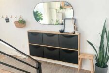 a black IKEA Trones piece with a stained countertop is a lovely idea for storage in a small entryway, it looks elegant