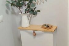 a small IKEA Trones piece with leather pulls and a stained countertop is a lovely idea for a small entryway