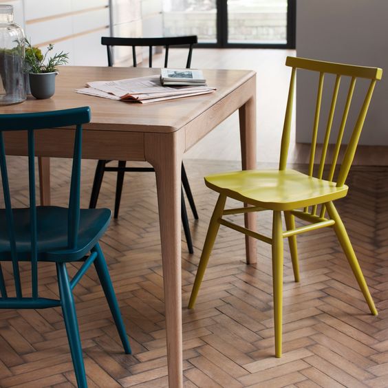 make your simple chairs catchy using different paints to create a bold dining space