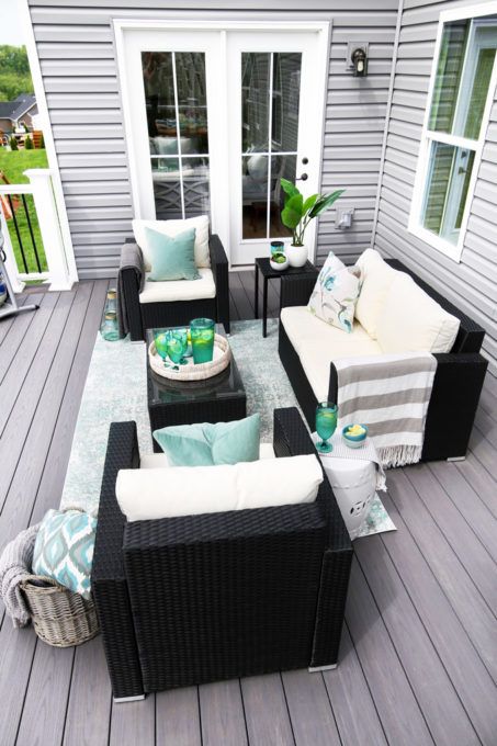 a neutral summer deck done with aqua green accents looks very bright and welcoming