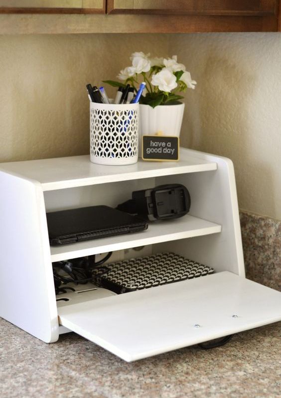 a charging station in a vintage breadbox is a fun and catchy idea for a kitchen, no one will guess