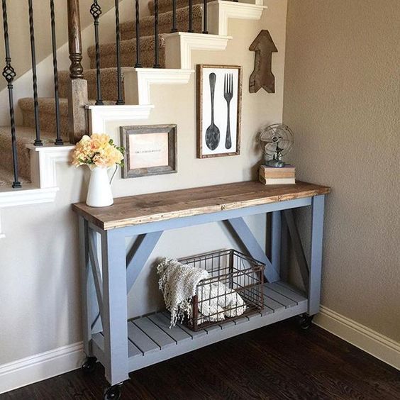 a slate grey pallet console table with a stained tabletop and casters is a timeless option for a rustic space