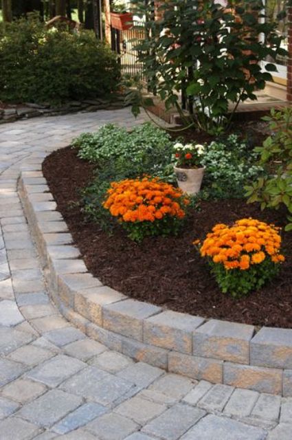 elegant outdoor bricks covering the pathway and the flower bed for a cohesive and more formal look