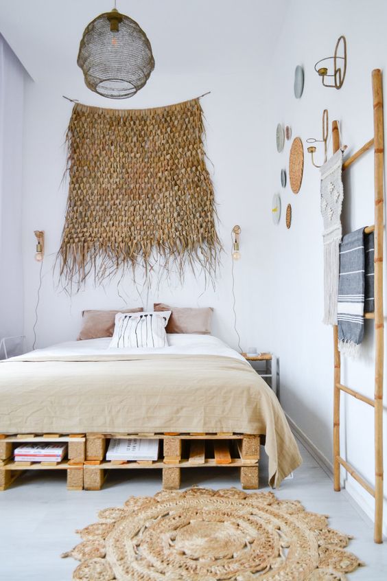 a comfy pallet bed with several layers of storage inside perfectly fits a boho chic bedroom