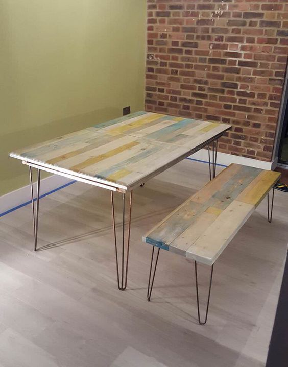 an upcycled pallet dining table and matching benches with hairpin legs and touches of whitewashed colors