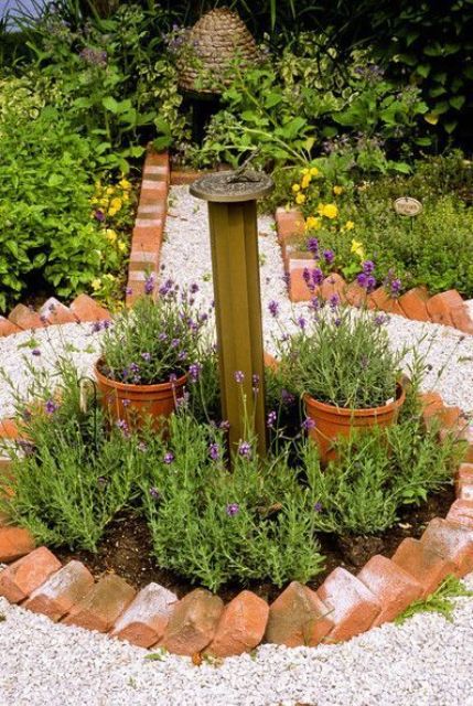 usual red bricks are a very cool idea for a garden bed and contrast with bright and neutral blooms and neutral gravel