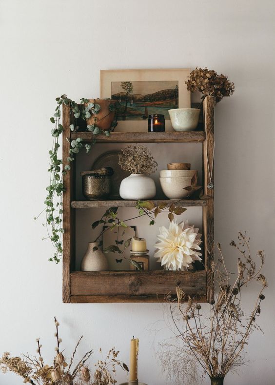 a rustic pallet shelf built of pallet wood and stained in a rich tone is a stylish storage furniture piece for many spaces