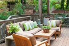 08 a cozy and welcoming summer deck with bright green and white touches and striped pillows for catchiness