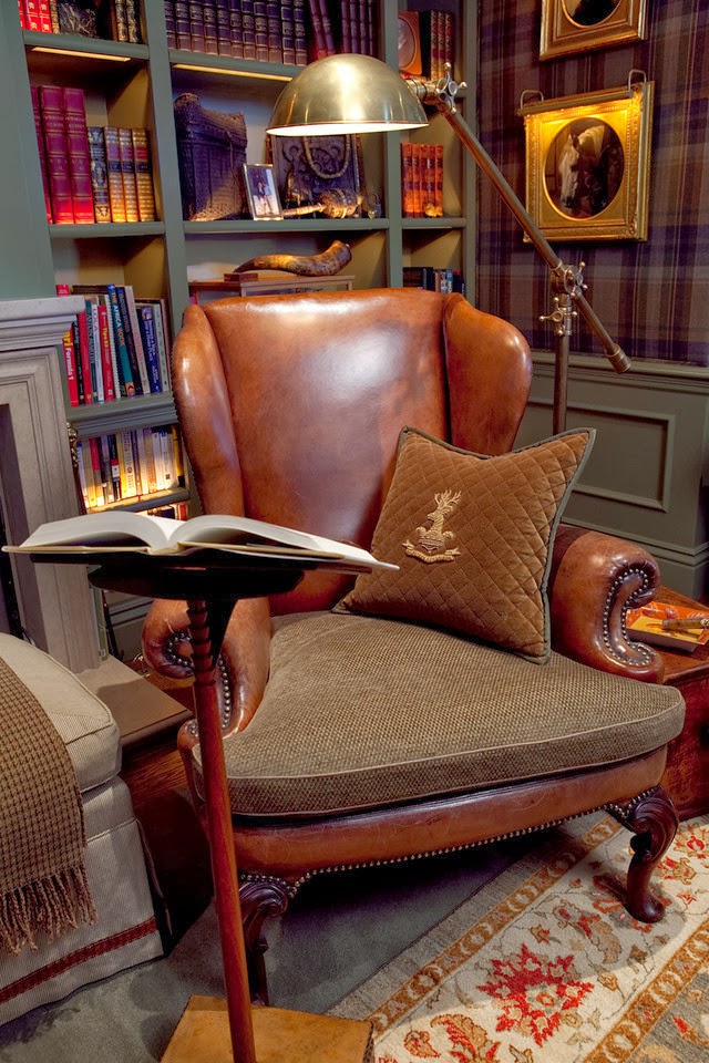 a large vintage leather and fabric chair is very refined, a metal floor lamp and a book stand for more comfort