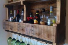 09 a rustic pallet wine rack with wine bottles and liquors and storage for glasses is a cool and simple DIY