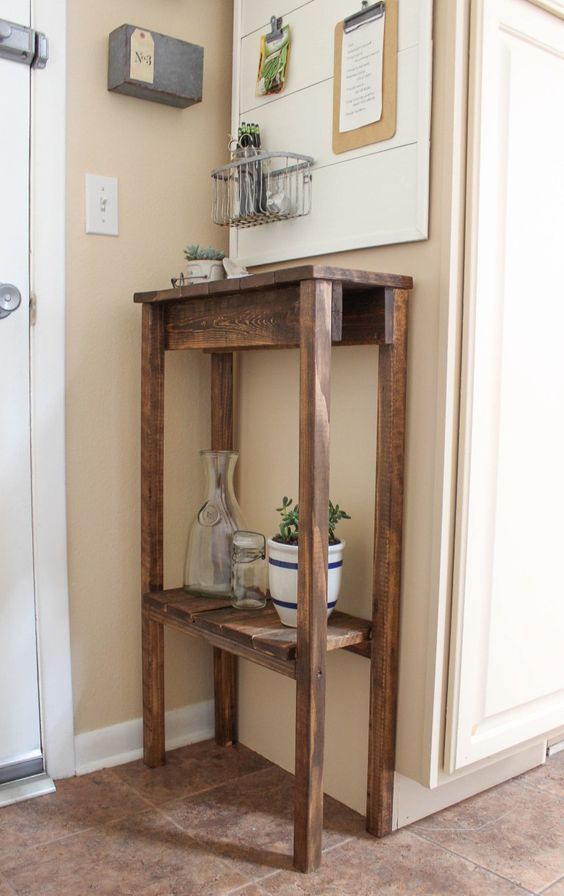 a rustic tall stained pallet console with an additional shelf for storage is a perfect idea for your tiny entryway