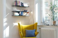 10 a mustard wingback chair with a blue pillow and a grey rug by the window is a cute idea