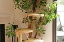 10 a nature-inspired cat tree with branches, plywood platforms and lots of fake greenery and jute rope