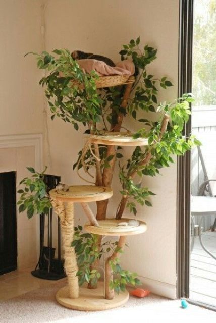 A nature inspired cat tree with branches, plywood platforms and lots of fake greenery and jute rope