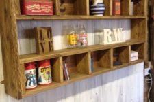 10 a rustic shelving unit with many compartments built of stained pallet wood is a cool DIY