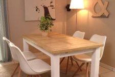 10 a simple indoor-outdoor dining table with a tabletop made of pallet wood and a white base plus white chairs