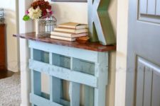 11 a vintage-inspired blue console table of a pallet with a rich-colored wooden tabletop is ideal for a sleek space