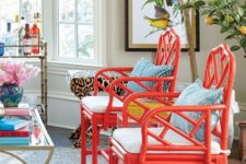 11 super bold red chairs with white cushions and blue pillows will immediately spruce up the space