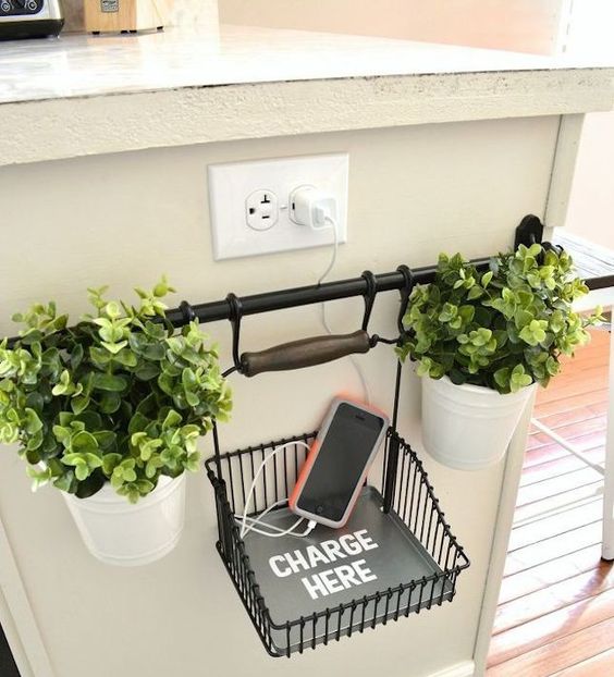 a holder under the sockets and a charging wire basket and potted greenery for a cool and chic look