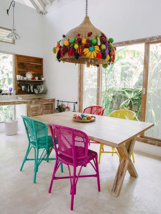 painted wicker chairs and a wicker lampshade decorated with faux fruit for a tropical dining space