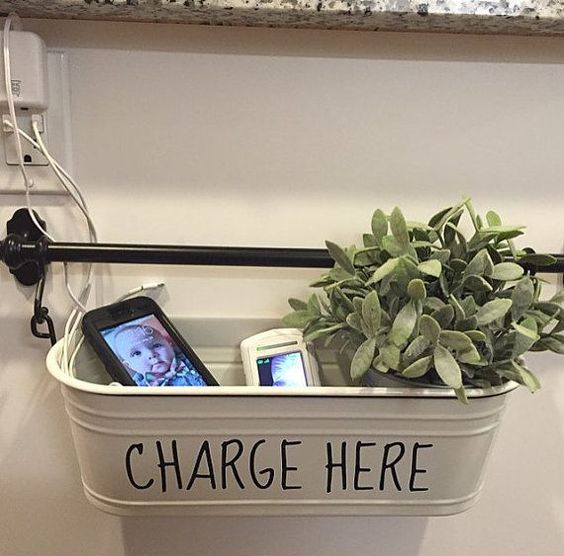 a holder with a hanging metal tub for charging and potted greenery can be DIYed very fast