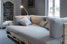 14 a pallet daybed with a back and casters, fitted with a comfy mattress and pillows on top