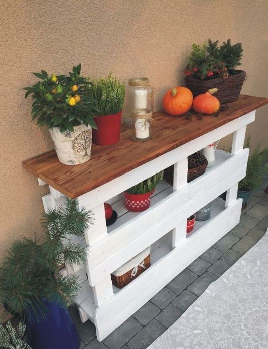 a cozy rustic console table made of two pallets in white and a stained wooden tabletop looks cool