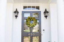15 a navy door with glass, navy patterned planters with ferns and vintage lamps over the pots